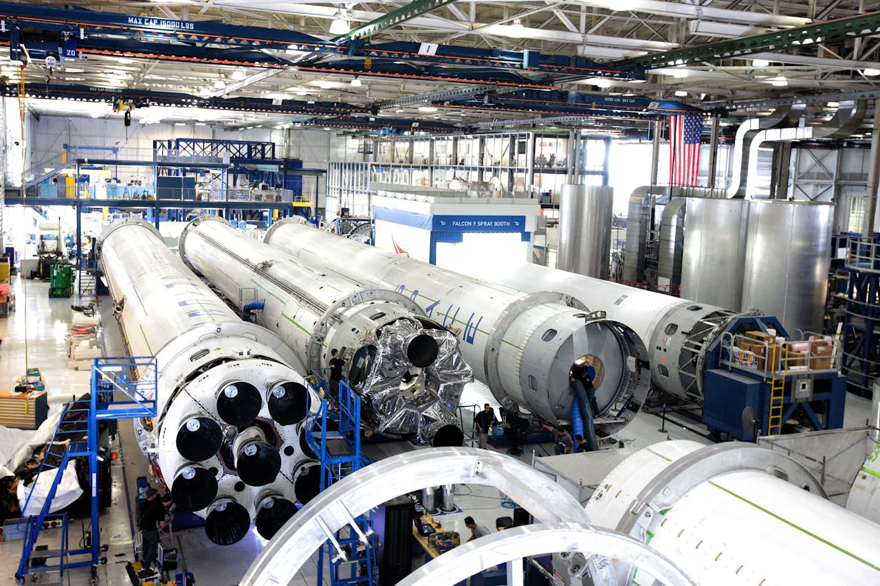 journey View of a spacecraft assembly line with rockets in a spacious hangar.